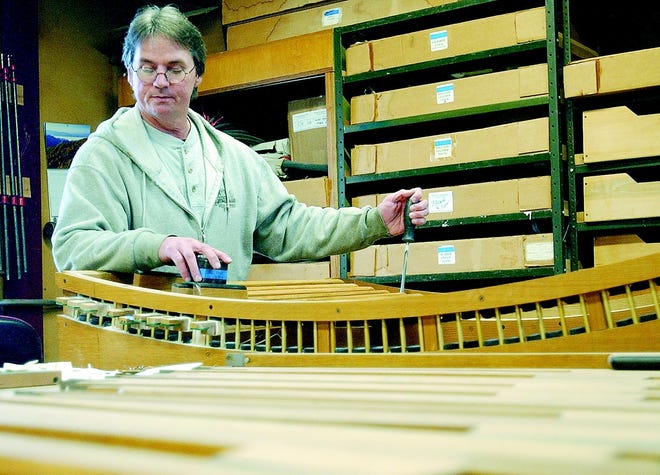Tony Martino of Canandaigua adjusts the tension on pedal keys at Parsons Pipe Organs. The Bristol company will be part of an international consortium that is charged with recreating an 18th century organ.