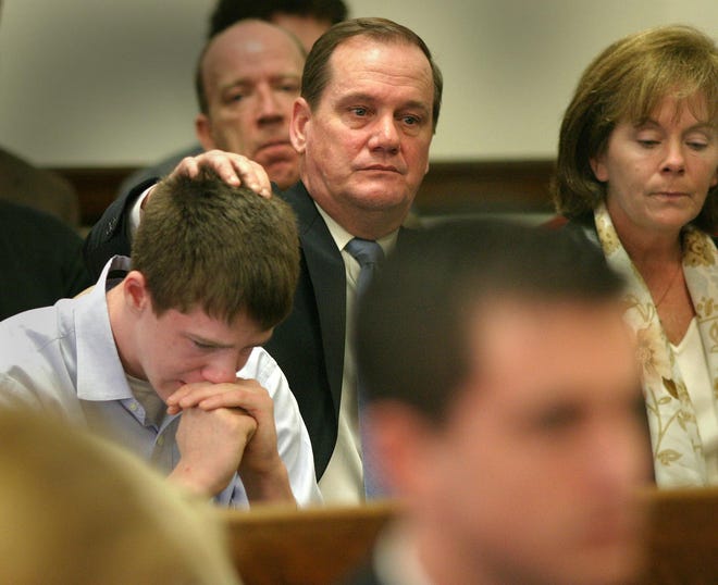 Thomas Nee tries to console his son, Edward, after Superior Court Judge Charles Grabau sentenced his brother, Joseph Nee, to 2 1/2 years in prison. At right is Gail Nee, the boys’ mother.