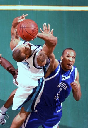 UNCW's Montez Downey attempts the shot against Georgia State's Trey Hampton during the first half of their basketball matchup on Wednesday February 20. For more photos from the game, visit www.starnewsonline.com(PHOTO BY KATE LORD/WILMINGTON STAR-NEWS)