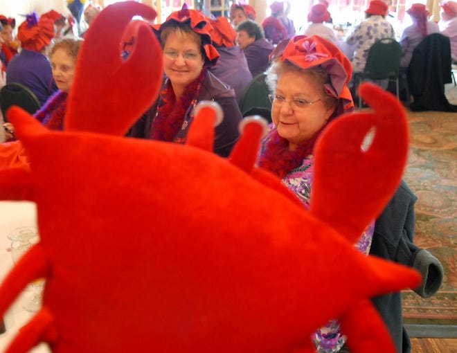 Loretta Wilson of Norwich, right, and Lynn Brulotte of Lisbon, left, talk with Gloria Lafferty of Norwich, wearing a lobster hat, during the 5th annual brunch of the Red Hot Strutters, part of the Red Hat Society, at the Holiday Inn in Norwich on Saturday, February 23, 2008.