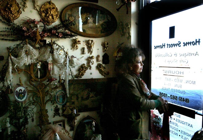 Leah Clifford gazes out the door of her antiques shop, Home Sweet Home, last week in Newburgh. Clifford moved her business to 211 South Plank Square hoping business would pick up, but it hasn’t.