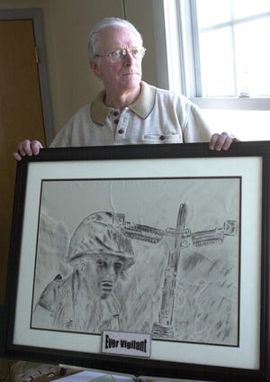 John A. Webster of Malden displays a charcoal drawing that depicts an American soldier in Vietnam.