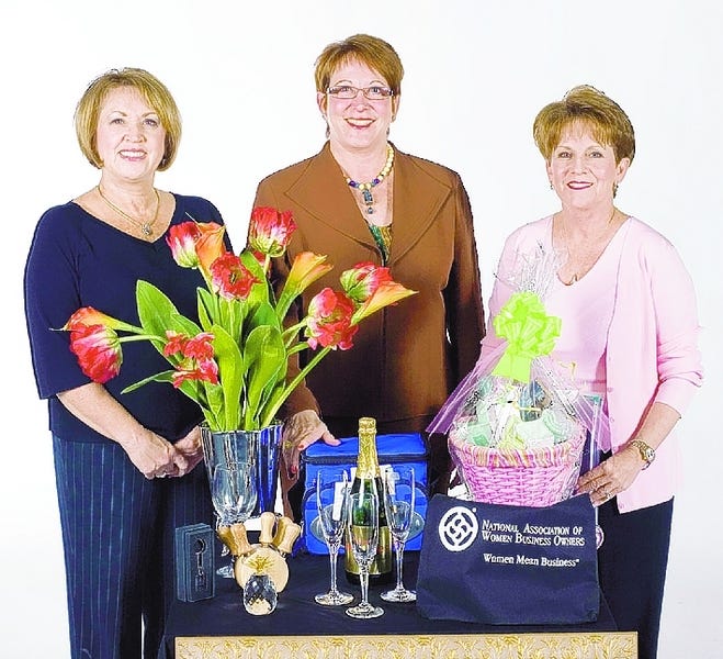 PROMOTING THE SILENT AUCTION are, from left, Marcia Peacock, Laura Swartswelder and Vicki White.