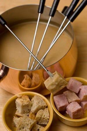 Light Cheddar and Ale Fondue is seen in this Thursday, Feb. 28, 2008 photo. A blend of low-fat and regular cheese along with pureed white beans makes this fondue tasty and creamy.  (AP Photo/Larry Crowe)