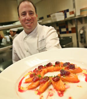 Executive chef Michael Schlow, of Villa Matta Restaurant in Boston's Park PLaza, prepares Salmon Citrus Shashimi.