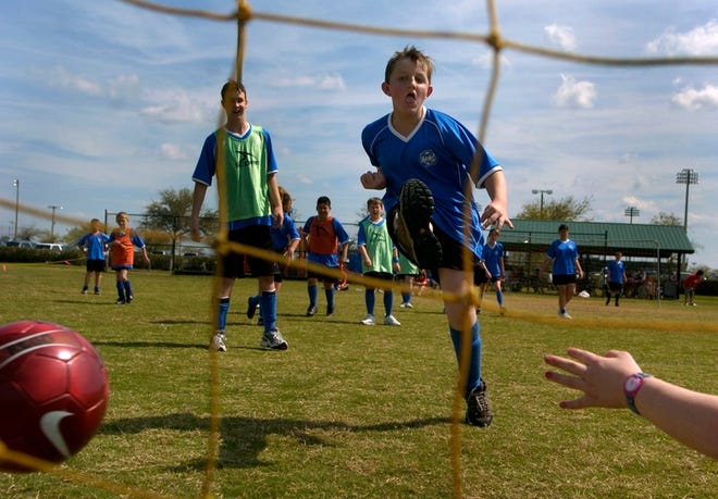 dan.wagner@heraldtribune.com
 Chase Harrison, 13, of Sarasota scores a goal during a TOPSoccer game Saturday in Lakewood Ranch.