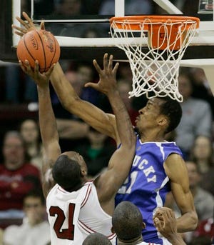 Kentucky's Perry Stevenson, right, blocks the shot of South Carolina's Mike Holmes, left, during the second half Wednesday in Columbia, S.C.