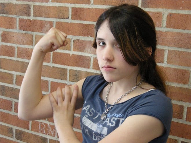 Erica Amato, a seventh-grader at Broad Meadows Middle School in Quincy, strikes a Rosie the Riveter pose. The cultural icon came to represent the women who worked in the manufacturing plants during World War II.