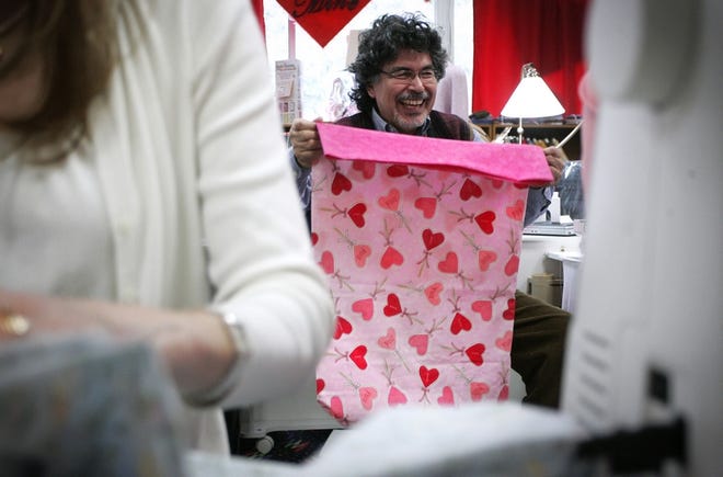 Cancer survivor Arthur Alvarez works with fellow ConKerr Cancer group members to sew brightly colored pillowcases for children going through cancer treatment at Shands Children's Hospital.