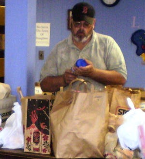 Steve Cullen at the post office food drive last May. He was sorting donations for St. Anthony's Market, a food pantry run by Immaculate Conception Church in Stoughton.