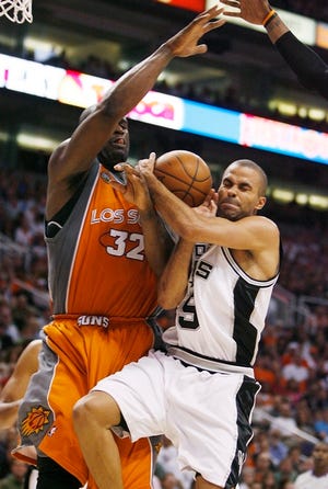 Muscling in
 San Antonio's Tony Parker, right, grimaces as he runs into Phoenix's Shaquille O'Neal in the fourth quarter Sunday in Phoenix.