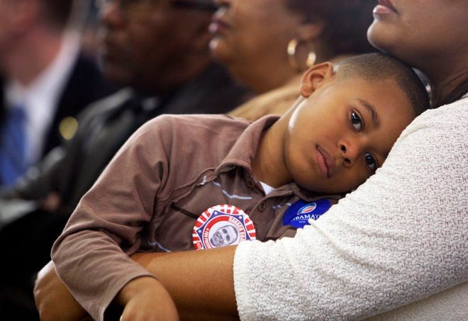 Ahmir Tayor, 5, is held by his mother Jamila Taylor, both from Starkville, Miss., as the listen to Democratic presidential hopeful Sen. Barack Obama, D-Ill., speak at town hall meeting at the Mississippi University for Women in Columbus, Miss., yesterday. Obama's rival Sen. Hillary Rodham Clinton, D-NY, campaigned in Mississippi last week and spent yesterday in Pennsylvania, which holds its primary April 22.