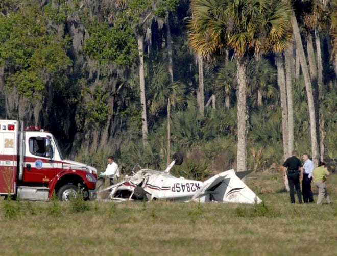 Martin County Fire and Rescue personnel work the scene of an airplane crash that killed four people today near Indiantown.