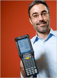 Thomas Watson, president of Asset Management International, with an 'Asset Track' device, which tracks technology equipment, including computers and phones, for companies.
