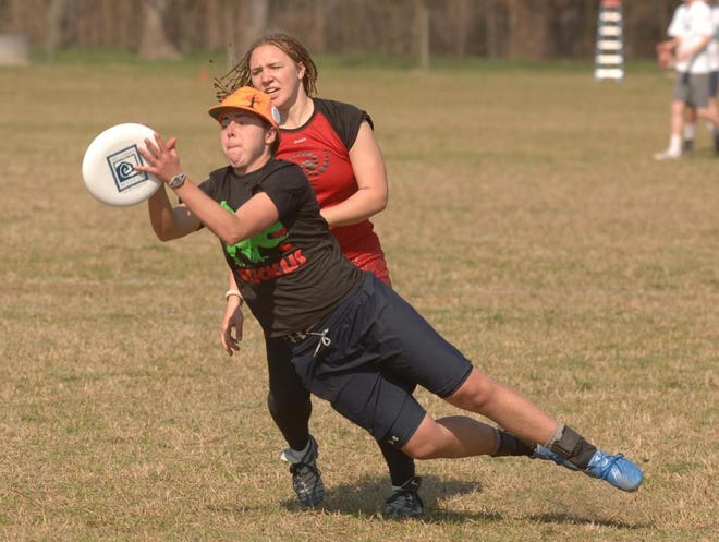 The University of Vermont's Erica Bryan catches the disc as she is defended by Wesleyan's Anna Williams during Thursday's High Tide Ultimate Frisbee championship match. Richard Burkhart/Savannah Morning News