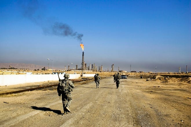 U.S. troops at the oil refinery in Baiji, Iraq, in February. Instead of fueling Iraq's economic recovery, the sea of oil under the country is causing corruption and paying for the insurgency.
