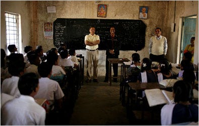 Dilip Ratha of the World Bank, standing at left, spoke last month to students at a school in his hometown, Sindhekela, India.