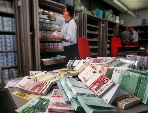 Euro banknotes are piled up on a table in the foreign exchange department of UBS bank in Zurich, Switzerland, in this Dec. 13, 2001 file photo. The euro clawed its way to another record high in trading Monday March 17, 2008, crossing US$1.59 before it tumbled lower, while the Japanese yen fell to another low after the latest emergency rate cut by the U.S. Federal Reserve failed to bolster the dollar.