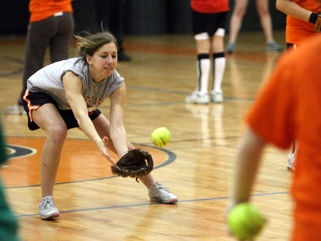 16 year old Alex Finn catches a ball during the first day of tryouts for the Oliver Ames High School softball team Monday afternoon at Oliver Ames High School in Easton.