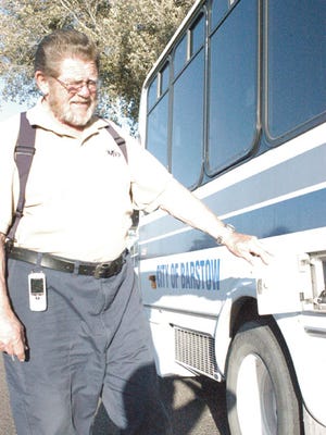 MV Transit driver Gus Blocksom opens the fuel hatch of one of the city's buses outside City Hall on Thursday.
