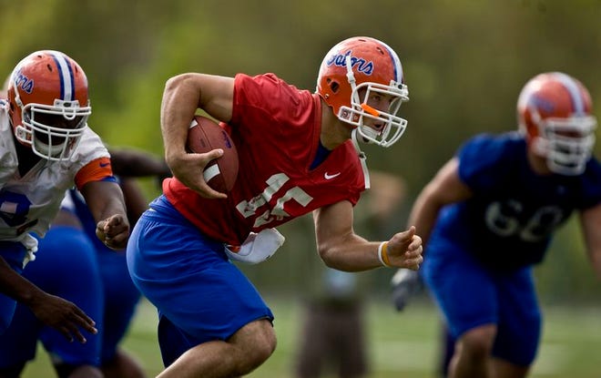 Florida quarterback Tim Tebow runs the ball during UF's practice Friday afternoon.