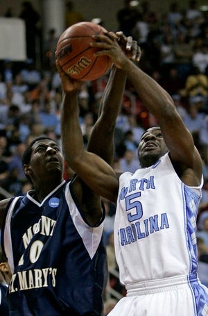 Powering insideNorth Carolina's Ty Lawson (5) drives to the basket past Mount St. Mary's Shawn Atupem during the second half of their first-round NCAA East Regional game Friday night in Raleigh, N.C.