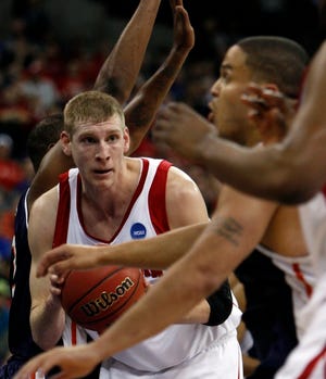 Impact guy
 Wisconsin forward Brian Butch, left, gets caught in traffic against Cal State Fullerton on Thursday.