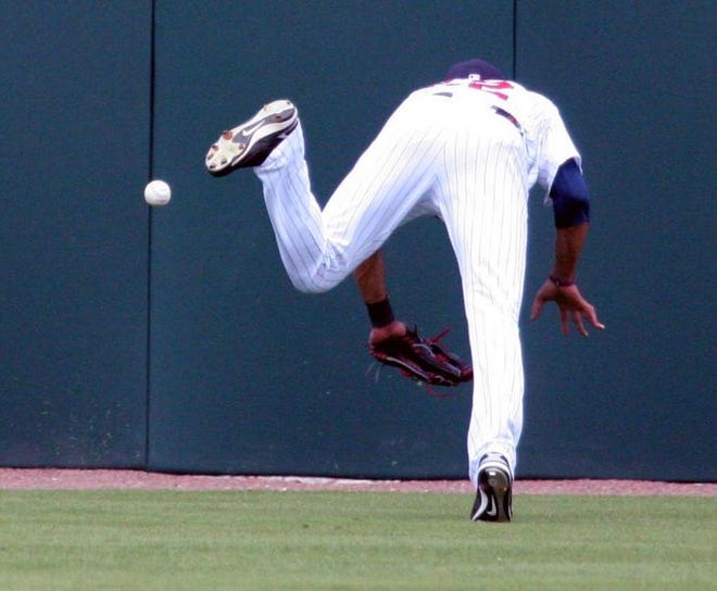 Minnesota center fielder Calros Gomez misplays a ball hit by Tampa Bay's Akinori Iwamura into a triple during the third inning of Wednesday's Grapefruit League game at Hammond Stadium in Fort Myers. It was a tough day for the rookie, who was hit with a pitch and later left the game with a hamstring cramp.