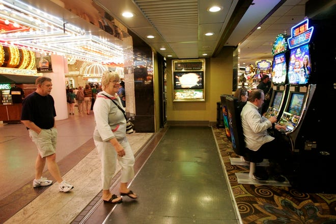 Tourists enter the Fremont hotel and casino in Las Vegas. Gambling was once thought recession-proof. But today, 48 states have some form of legal gambling and millions of Americans are within driving distance of a slot machine.