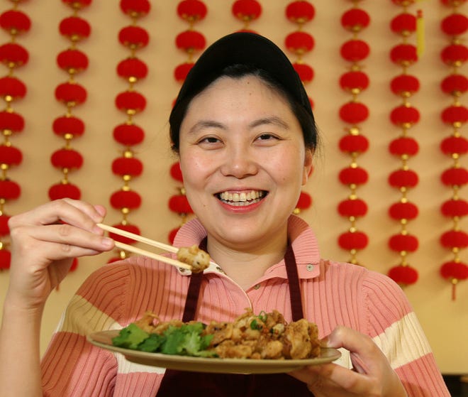 Sherry Feng, co-owner of A Taste of Taiwan, eats some salt and pepper squid.