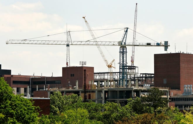 Large cranes line the sky along Archer Road near SW 13th Street as construction projects continue on the new Shands Cancer Hospital and a new building for biomedical sciences on the University of Florida campus.