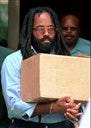 Mumia Abu-Jamal, convicted of killing Philadelphia police officer Daniel Faulkner in 1981, leaves a Philadelphia court July 12, 1995. A federal appeals court has upheld Abu-Jamal's conviction for murdering a Philadelphia police officer in 1981, but agreed with a lower court that he cannot be executed without a new penalty hearing.