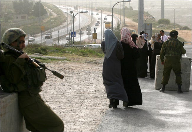 Israeli soldiers recently monitored access to A Tira, a village in the West Bank, via Highway 443, in the background.