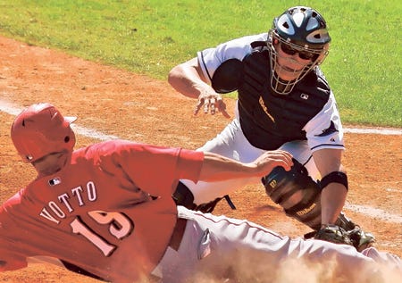TAMPA BAY CATCHER SHAWN RIGGINS, RIGHT, tags out Cincinnati's Joey Votto in the ninth inning Friday in the final spring game at Al Lang Stadium.