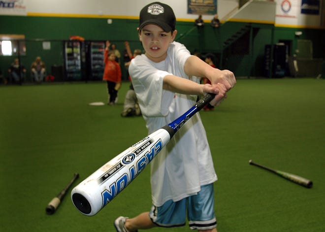 Christopher Moretti, 11, of Duxbury tries out a bat at Baseball Plus in Marshfield.