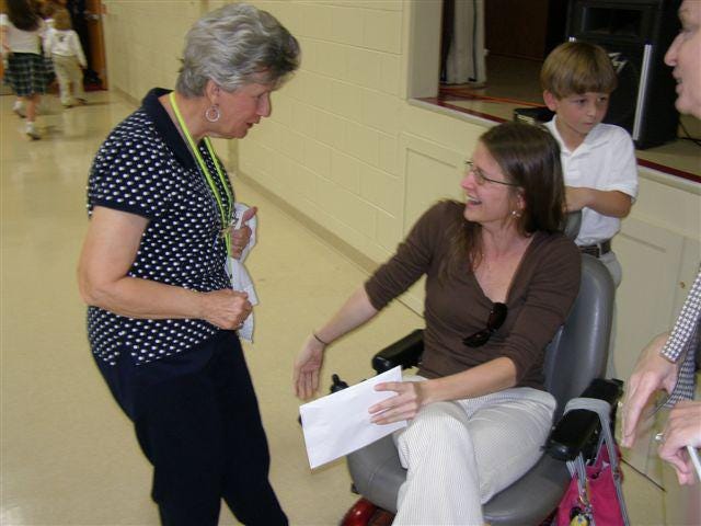 Lindsay greets her former kindergarten teacher, Dorothy Puckett.