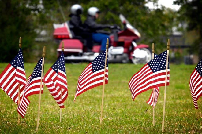 American flags are planted on the lawn at the Imperial Sugar Co. refinery in Port Wentworth on Sunday by motorcyclists participating in a fundraiser for the victims and families. Hunter McRae/Savannah Morning News
