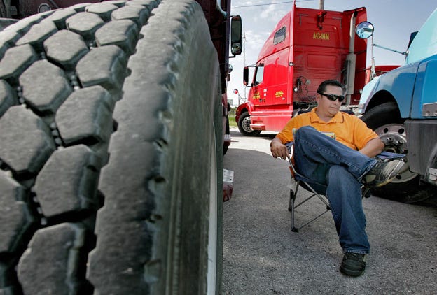 Ignacio Vergara, 43, of Tampa, Fla., sits in the shade near his parked truck Tuesday morning, April 1, 2008 near the Port of Tampa, Fla. The Owner-Operator Independent Drivers Association says many of its members believe diesel prices at more than $4 a gallon is making it difficult for them to stay in business.