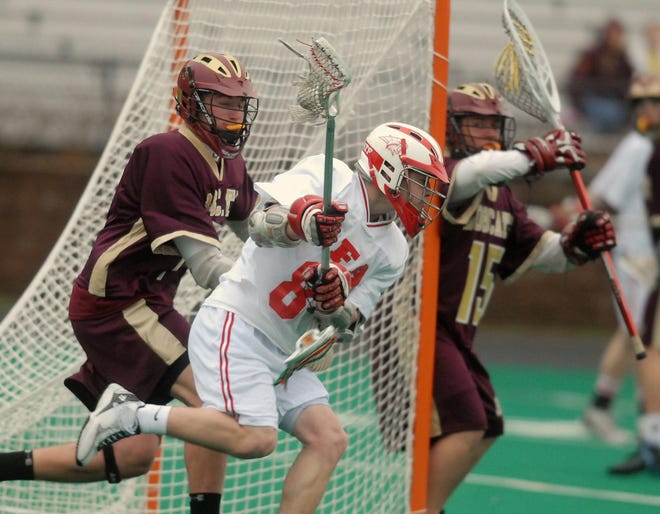 Norwich's Ryan Gillis, center, makes his way around South Windsor's goal to take a shot during a lacrosse game Friday, April 4, 2008, at Norwich Free Academy. South Windsor's Clayton Hillyer, left, tries to stop Gillis.