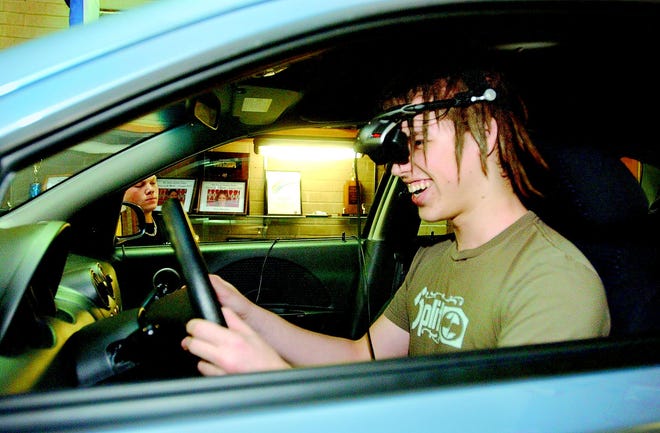 Wearing virtual reality headgear, Anthony Santini, a junior at Red Jacket High School, finds out what it would be like to drive with his ability impaired by drugs or alcohol. The school brought in an actual car with a software program that mimics the effects of intoxication. A community roundtable tomorrow evening will focus on the issue of underage drinking.