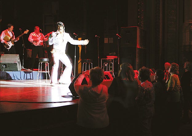 Several women flock to the stage to see Elvis impersonator Al Hull perform with the Legends Band last Wednesday night at the Orpheum Theatre.