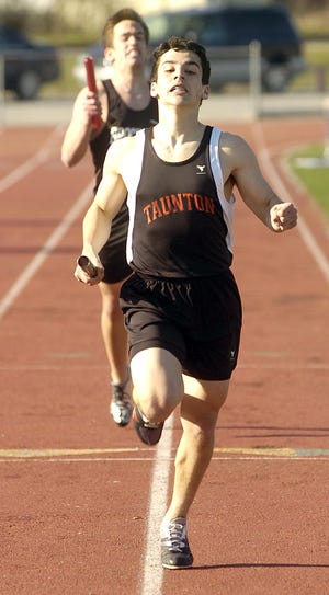 Taunton's Matt Camara runs the anchor leg for the Tigers' winning 4x400 relay team.