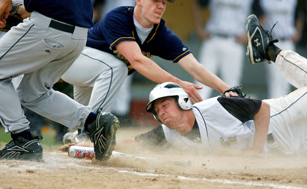 Galesburg High School's Kyle McGee slides into home but is tagged out by Woodruff pitcher Mitch Hidden during the bottom of the first inning Thursday afternoon at Sundberg Field.