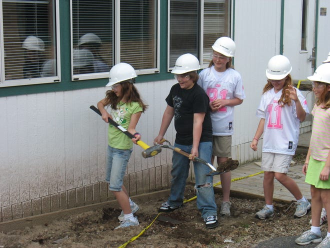 Steve Kloosterman/The Holland Sentinel
Douglas Elementary School fifth-graders Mary Cappelletti, Adam Kimball, Morgan Bush, Ashton Greene, Kailey Gehres and Taylor Slais took part Friday morning in a ceremonial smashing of the school? portable classrooms.
Construction on new classrooms will begin soon. The new classroom are expected to be ready for the fall.