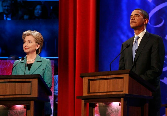 Democratic presidential hopefuls Sen. Barack Obama, D-Ill., right, and Sen. Hillary Rodham Clinton, D-N.Y. stand on stage prior to the start of their debate Wednesday night at the National Constitution Center in Philadelphia.