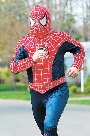 Comedian Earl "The Duke of Madness" Paresky gets some practice for his run in Monday's Boston Marathon in his "Spidey Suit" that he will wear along the course to raise money for charity.