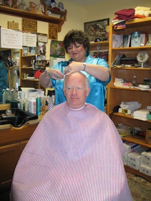 Clean cut: Mary Schreiber cuts David Baldwin’s hair Saturday at Mary’s Clippin’ Post. Baldwin has come to Schreiber for cuts for about 30 years and was one of her first customers when she opened her shop in Chillicothe. His wife, Judy, also comes to Schreiber.
