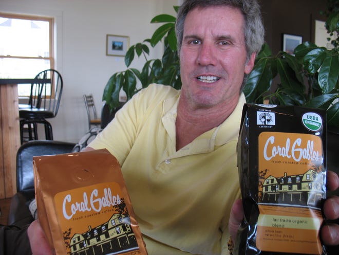 Mike Johnson, owner of Coral Gables in Saugatuck, shows a pair of the coffees he’s been selling for nearly three years. He said starting a private label program with a Lansing company has allowed him to hand pick his blends and better promote the business.