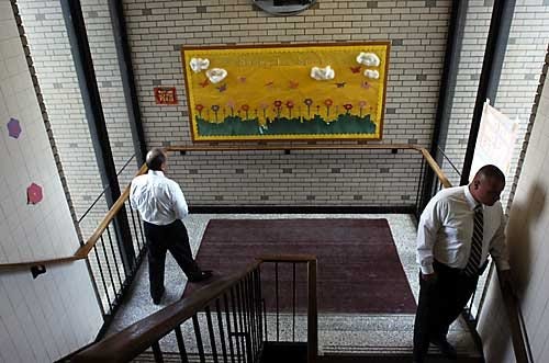 The Times/KEVIN LORENZI Monaca School Superintendent Michael Thomas, left, and principal Shawn McCreary walk through a stairwell connecting the Junior/Senior High School with the elementary classrooms as they lead a walking tour of Monaca's Junior/Senior High School Wednesday.