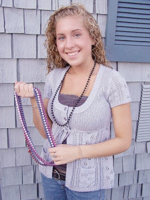 SUBMITTED PHOTO
CHERNOBYL CHILDREN'S FUND-RAISER: Molly Whalen of Middleboro will be selling Mardi Gras beads at a Chernobyl Children's Project event on May 9 at the Sheraton Braintree Hotel to raise money to bring Russian children to this area again this summer.